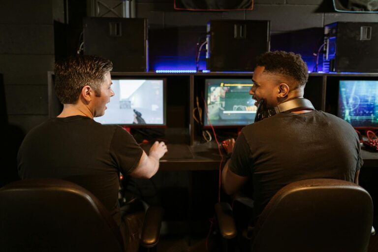 Two men engaged in an exciting gaming session in a modern cyber cafe.