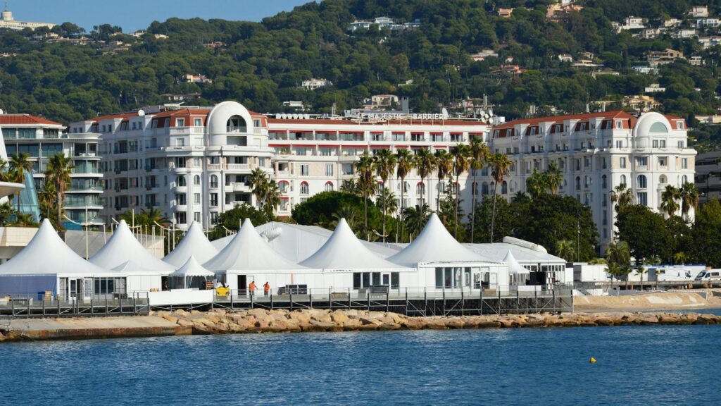 View of luxury hotels and white tents by the seashore in Cannes, France.